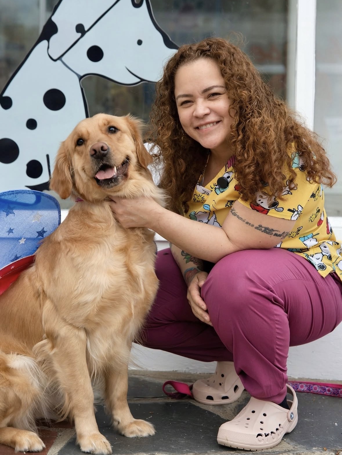 Natalia Silva, founder of Patriots Paw Boutique, with a golden retriever